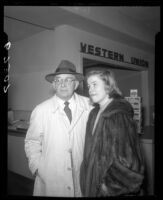 Actress Nancy Olson and her father, H.J. Olsom before Western Union counter at LAX, 1950