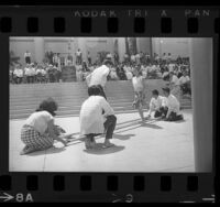 Filipino folk dancers performing tinikling dance on steps of Los Angeles City Hall, 1966