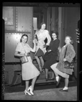 Members of Ballet Russe de Monte Carlo posing as they arrive at train station in Los Angeles, Calif., 1947