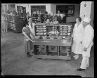 Los Angeles County General Hospital kitchen staff pose beside a food transport cart, Los Angeles, [1934]