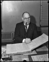 Captain Bert Wallis filling out ledger, Los Angeles, 1930s