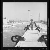 Tom Johnson walks between aeration tanks at Whittier Narrows Water Reclamation Plant, El Monte, Calif., 1962