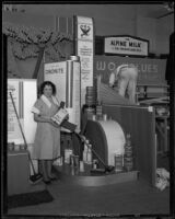 Woman stands in front of the Standard Oil Company exhibit at the Food and Household Show, Los Angeles, 1933