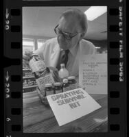 Health food store owner, Robert Boyd, displaying "fruit fly survival kit" in Los Altos, Calif., 1981