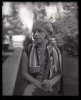 Millicent Sunday seated in a chair in a park or yard, Los Angeles, 1928