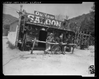 Three men standing at saloon in replica of Indian Frontier Village in Mint Canyon, Calif., 1965