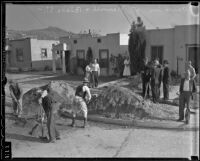 Sewer maintenance workers fix the damage falling dirt caused after the death of Peter Sanchez, Los Angeles, 1936