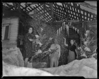 Bunny Gilmore and two unidentified men and an unidentified woman at the site of the Christmas House they helped build, Los Angeles, 1938