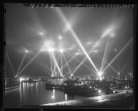 Navy battleships, cruisers, air craft carriers, and destroyers putting on light show in Long Beach Harbor, Calif., 1946