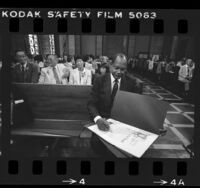 Los Angeles Mayor Tom Bradley signing proclamations for Japanese American World War II internees, 1984