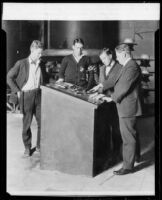 California Institute of Technology Professor Royal W. Sorensen and three students at switch mechanism, [Pasadena], 1929