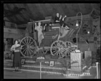 Three women pose with the Ontario display at the National Orange Show, San Bernardino, 1933