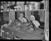 Bob Boyd & Chef George Arnold cutting beef for Thanksgiving for the Rescue Mission, Los Angeles, 1936