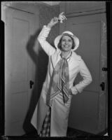 Aimee McPherson holding handkerchief in her hand and smiling, Los Angeles, 1932