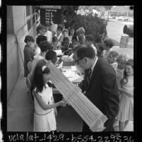 William F. Fitzgerald showing giant slide rule to students at California Museum of Science and Industry, Los Angeles, 1965