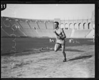 John Powers, Occidental College student, running track at the Coliseum, Los Angeles, circa 1924