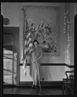 Margaret Sherlock, World War I naval veteran, poses with the American Flag, Los Angeles, 1935