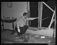 Lyndon Foster inspects the damage done to his apartment, Los Angeles, 1935