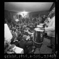 Hugh Masekela performing in Donn Chappellet's living room as crowd watches, Beverly Hills, Calif., 1966