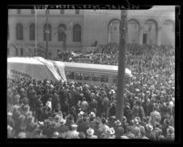 Crowd at City Hall watching unveiling of new Los Angeles Railway streetcars at Transportation Week celebration, 1937