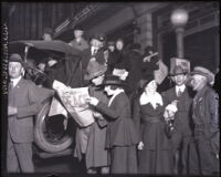 Couple reading Los Angeles Times with huge headline reading "Peace," Los Angeles, 1918