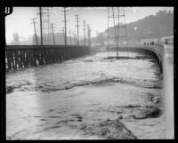 Glendale bridge destroyed by a storm flooding in the Los Angeles River, Los Angeles, 1927