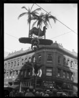 Camel sculpture mounted on wires over Shriners' parade, Los Angeles, 1925