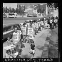 Women Strike for Peace members wearing signs reading "Stop This War Voter's Peace Pledge…" marching at Old Plaza in Los Angeles, Calif., 1966