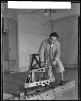 California Institute of Technology professor Arthur L. Klein demonstrating a balance scale, Pasadena, 1932