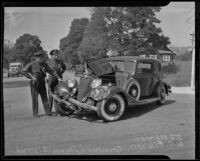 Officers W. A. Ellenson and J. S. Upwan examine a car wreck, Los Angeles, 1936