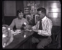 Laura Bullock and Eugene W. Biscailuz with the belongings of an escaped convict, Los Angeles, 1919