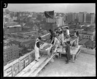 Female construction workers haul and pour concrete while on the roof of Hotel Figueroa, Los Angeles, 1926