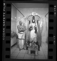 Priest with statue of Hindu god Shiva at Hindu Temple near Malibu, Calif., 1984