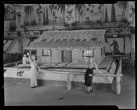 Two women stand in front of the Corona display at the National Orange Show, San Bernardino, 1933