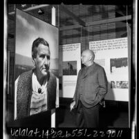 Composer Virgil Thomson studying large photograph of Gertrude Stein at UCLA exhibit, 1965