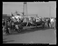 Crowd viewing a 20-foot basking shark caught by fishermen in Long Beach, Calif., 1955