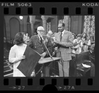 General of the United States Army, Omar Nelson Bradley flanked by Peggy Stevenson and Tom Bradley in city council chambers Los Angeles, Calif., 1976