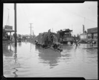 Commercial street flooded during or after a heavy rainstorm, Los Angeles County, 1927