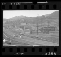 Automobiles passing billboards along Ventura Freeway near Agoura Hills, Calif., 1967