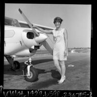 Woman pilot, Mrs. Irwin Title standing in front of single engine plane in Torrance, Calif., 1967