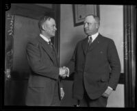 Harold Davis and Asa Keyes, district attorneys, shaking hands, Los Angeles, 1924-1929