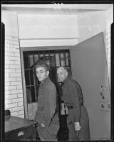 Willard James Turtine is escorted through jail by guard Floyd Mellor, Los Angeles, 1936