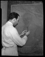 Carmelo Barbera working on a relief sculpture of Thomas Edison, Los Angeles, 1933