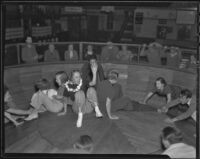 Ann McNaghten celebrating at Venice Beach fun house, Venice (Los Angeles), 1936