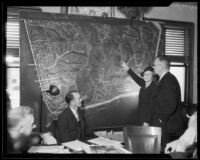 Los Angeles Park Commission president Mabel V. Socha and Chief Deputy District Attorney Robert Stewart with large map of Griffith Park, [Los Angeles?], [1933?]