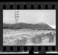 Los Angeles River filled with a muddy torrent after a rainstorm, Los Feliz (Los Agneles), 1969