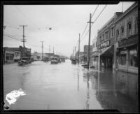 Commercial street flooded during or after a rainstorm, [Los Angeles County?], 1927