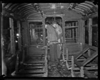 Officials investigating scorched street car on Third and Bixel, Los Angeles, 1934