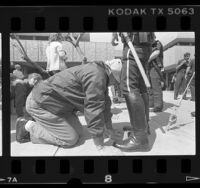 Anti-abortionists on hands and knees before police during demonstration in Los Angeles, Calif., 1989