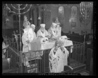 Three men reading scroll as another blows shofar during Yom Kippur service at Jewish Home for the Aging in Los Angeles, Calif., 1945